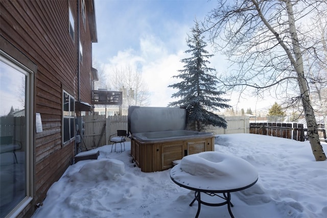 snowy yard featuring a hot tub