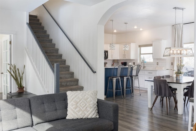 living room with dark hardwood / wood-style flooring and sink