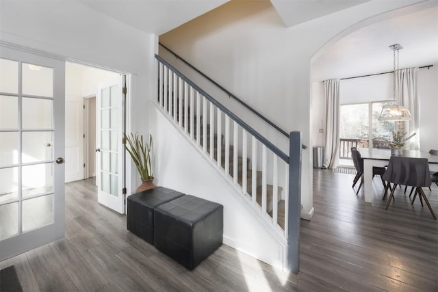 staircase featuring hardwood / wood-style floors and french doors