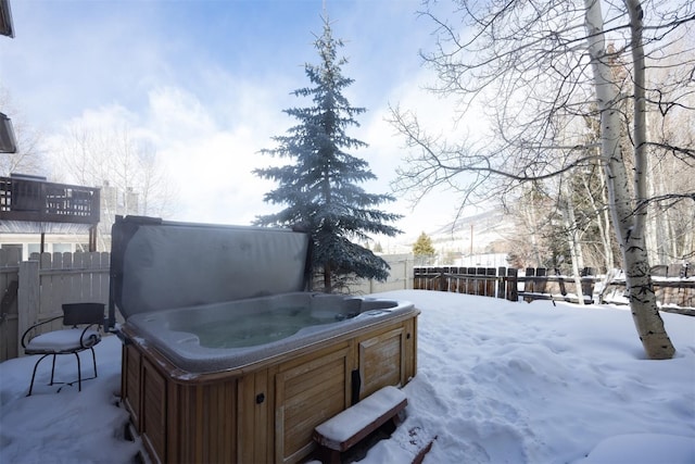 snowy yard featuring a hot tub