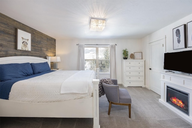 bedroom with carpet floors and wood walls