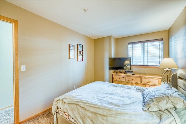 bedroom featuring carpet flooring and baseboards