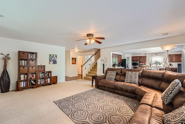 living room featuring ceiling fan and light carpet