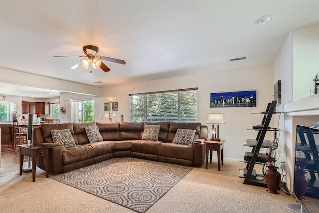 living room with light colored carpet and ceiling fan