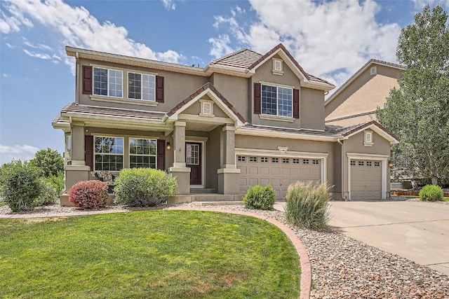 view of front of property with a front yard and a garage