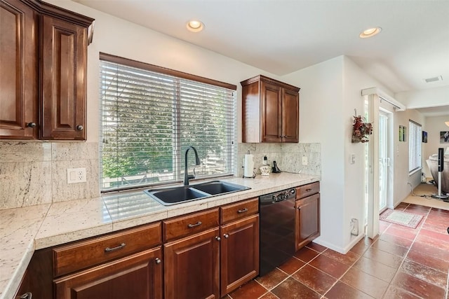 kitchen featuring backsplash, dark brown cabinetry, dark tile patterned floors, sink, and black dishwasher