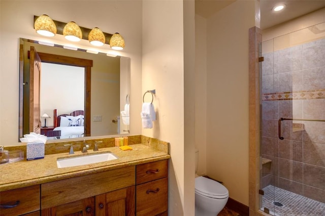 bathroom featuring toilet, walk in shower, and vanity