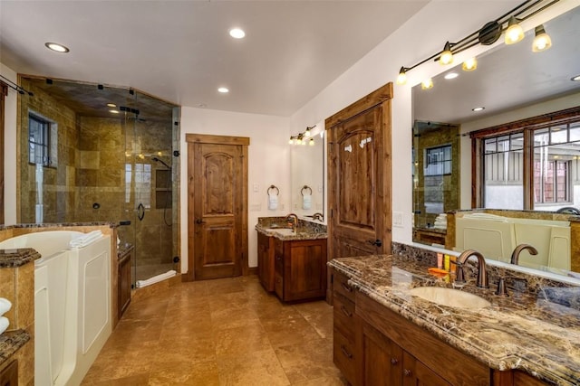 bathroom featuring separate shower and tub and vanity