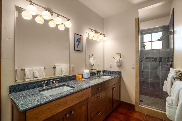 bathroom with a shower with door, tile patterned floors, and vanity