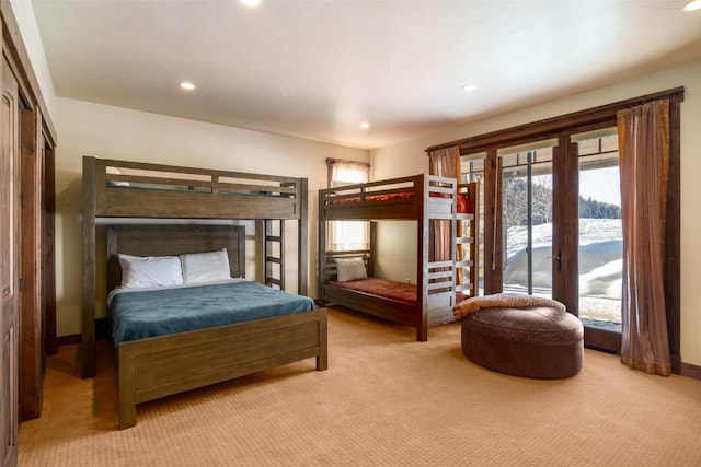 bedroom featuring light carpet, french doors, and access to outside