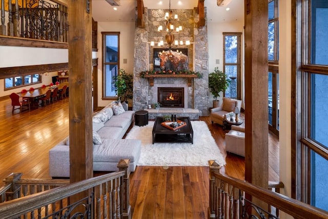 living room with a fireplace, hardwood / wood-style flooring, and a chandelier