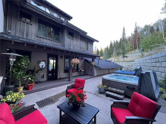 view of patio with a wooden deck and a hot tub