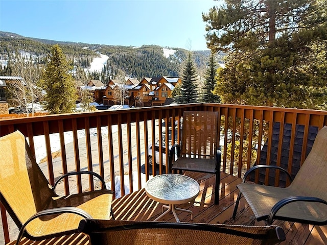 balcony featuring a residential view, a mountain view, and a wooded view