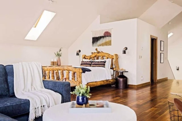 bedroom with vaulted ceiling with skylight, dark wood finished floors, and baseboards