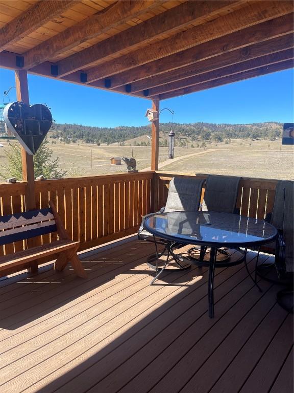 wooden terrace featuring a rural view