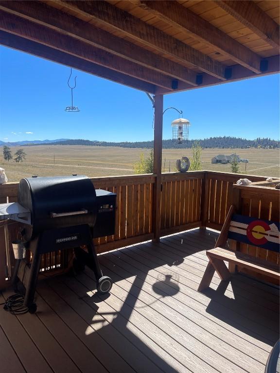 wooden deck with grilling area and a rural view