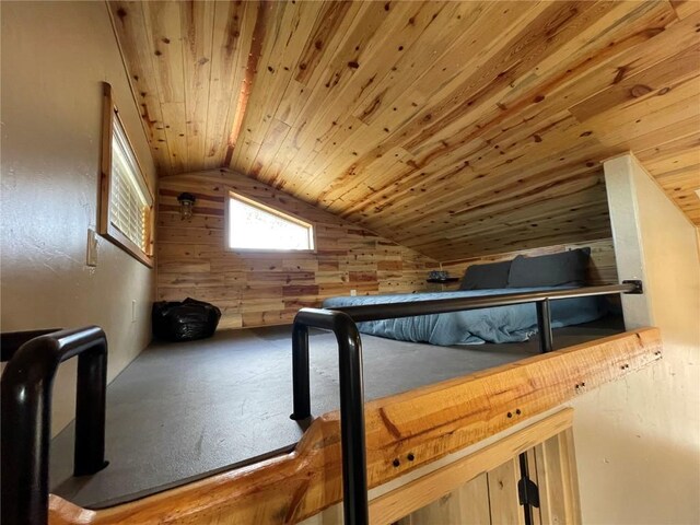 additional living space featuring wood walls, lofted ceiling, and wood ceiling