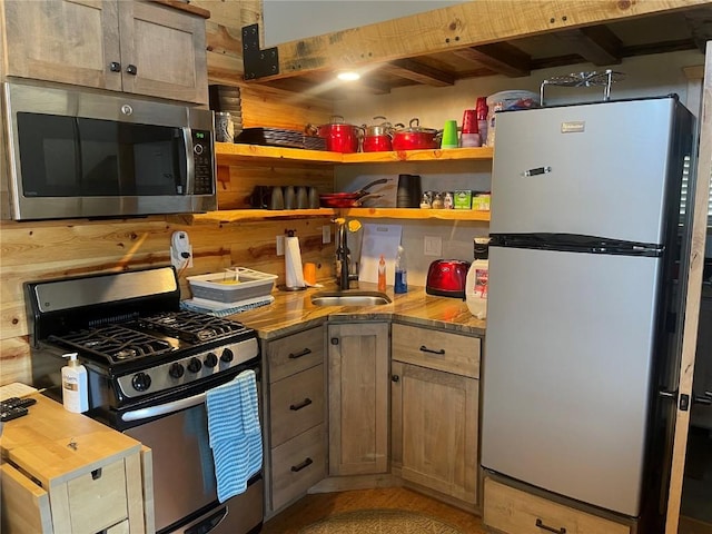 kitchen with sink, stainless steel appliances, and wooden counters