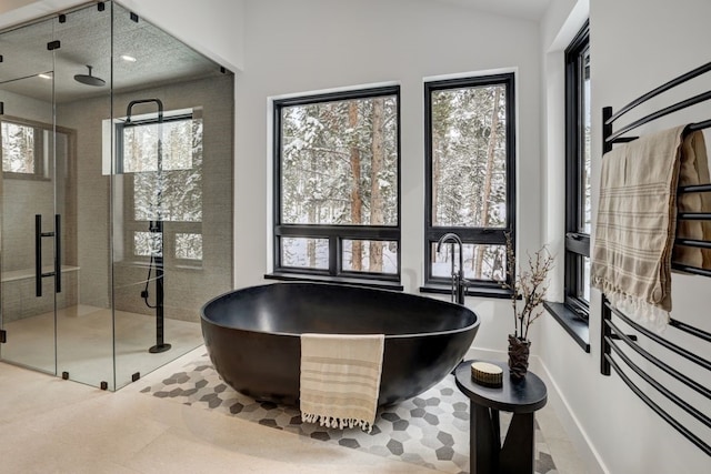 bathroom with tile patterned flooring, a healthy amount of sunlight, and independent shower and bath