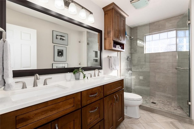 bathroom featuring vanity, tile patterned floors, a shower with door, and toilet