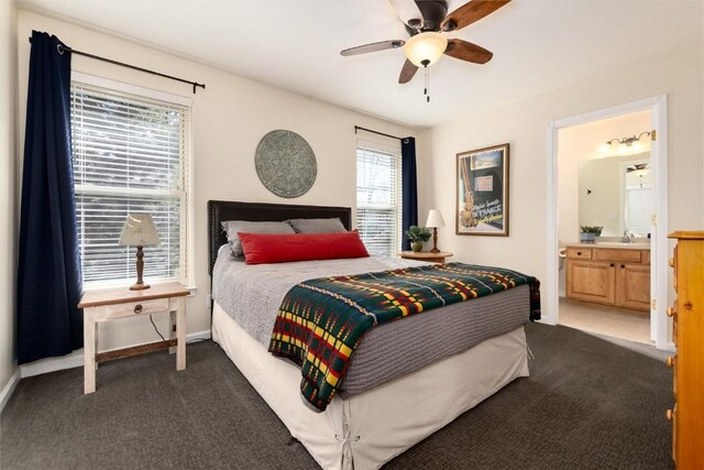 bedroom with sink, ensuite bathroom, ceiling fan, and carpet flooring