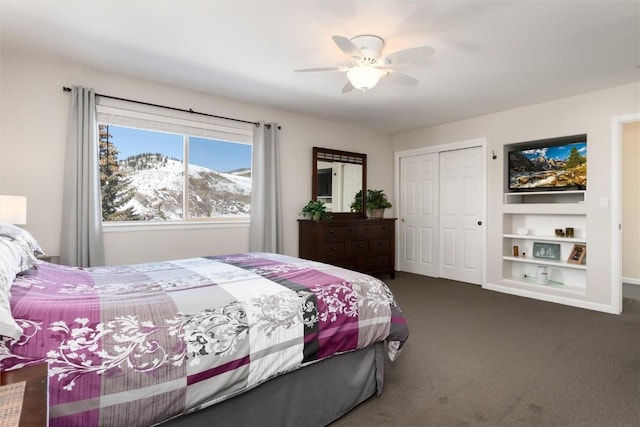 bedroom featuring dark colored carpet, ceiling fan, and a closet