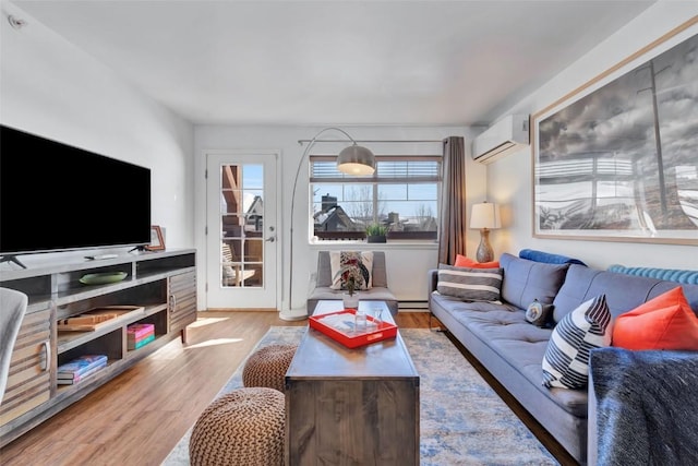 living room with a baseboard radiator, wood finished floors, and a wall mounted air conditioner