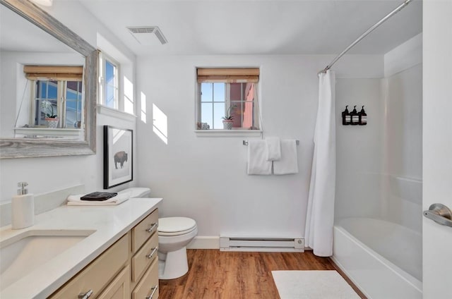 full bathroom featuring visible vents, toilet, a baseboard heating unit, vanity, and wood finished floors