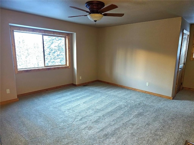 carpeted spare room with ceiling fan