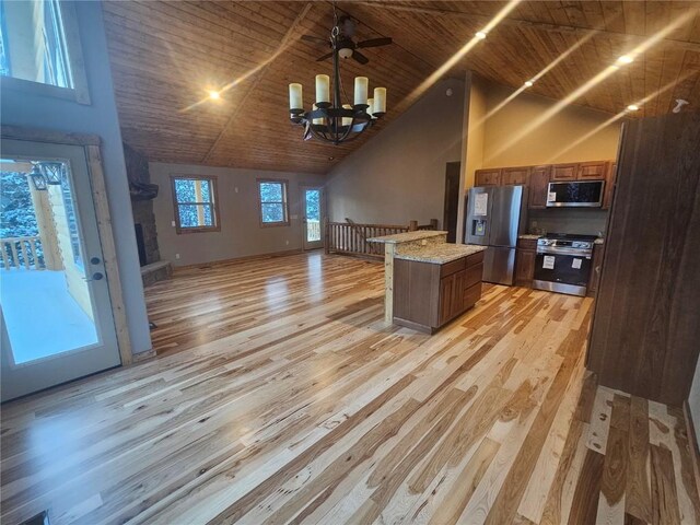 kitchen with appliances with stainless steel finishes, light wood-type flooring, light stone counters, high vaulted ceiling, and wooden ceiling