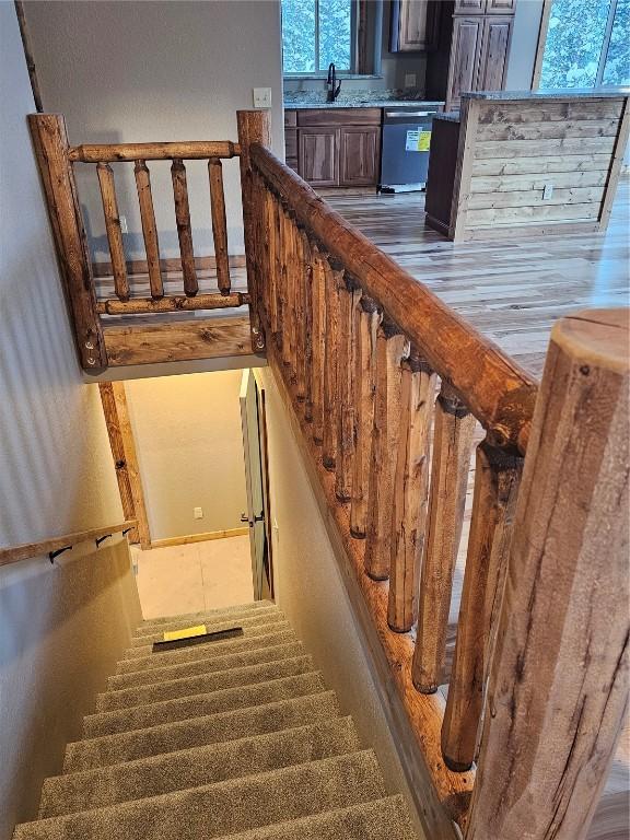 stairs with sink and a healthy amount of sunlight