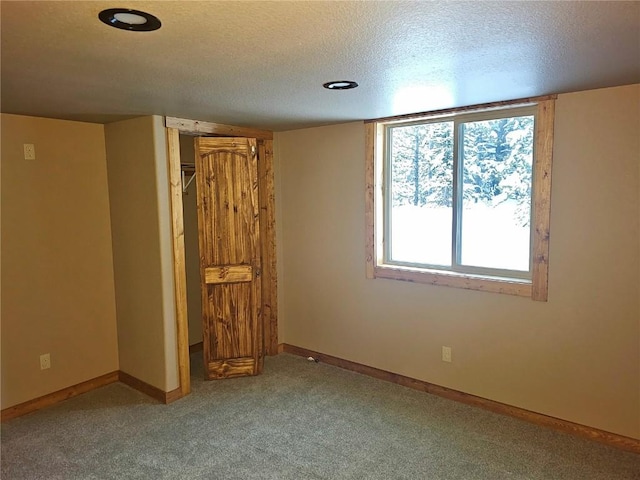 unfurnished bedroom featuring carpet and a textured ceiling