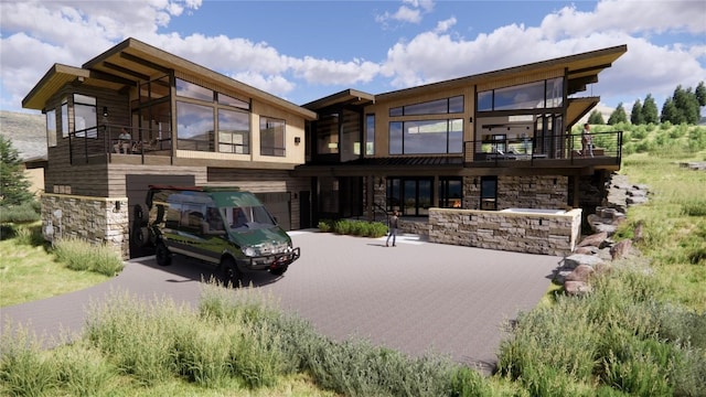 rear view of house with a balcony and a garage