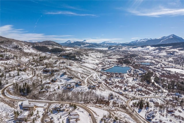 snowy aerial view with a mountain view