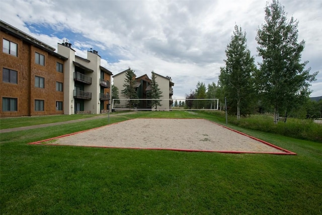 surrounding community featuring a yard and volleyball court