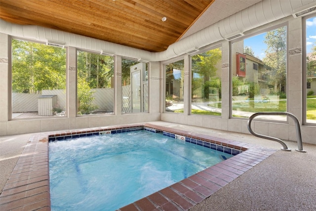 view of swimming pool featuring an in ground hot tub