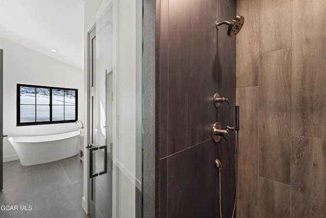 bathroom featuring vaulted ceiling and separate shower and tub