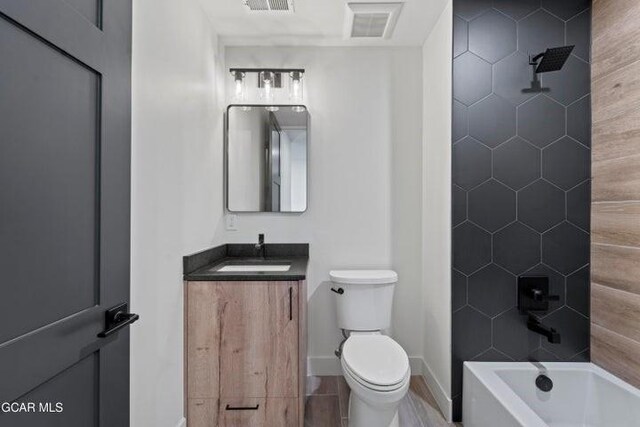 full bathroom featuring shower / bathing tub combination, vanity, and toilet