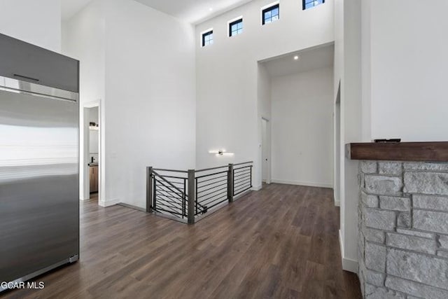 hallway featuring dark hardwood / wood-style floors and a high ceiling