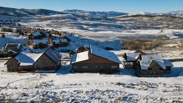 snowy aerial view with a mountain view