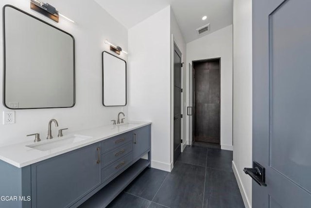 bathroom featuring tile patterned flooring, vanity, and vaulted ceiling