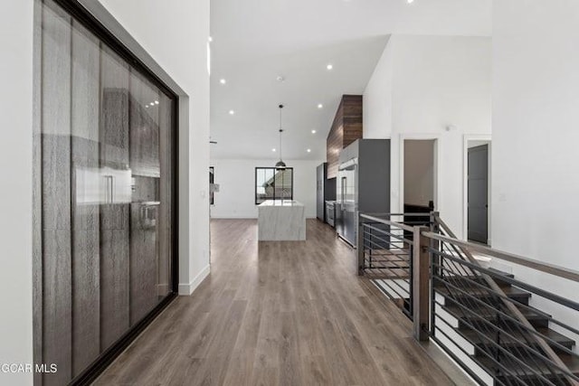 hall with hardwood / wood-style flooring