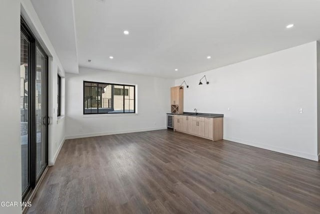 unfurnished living room with dark hardwood / wood-style floors