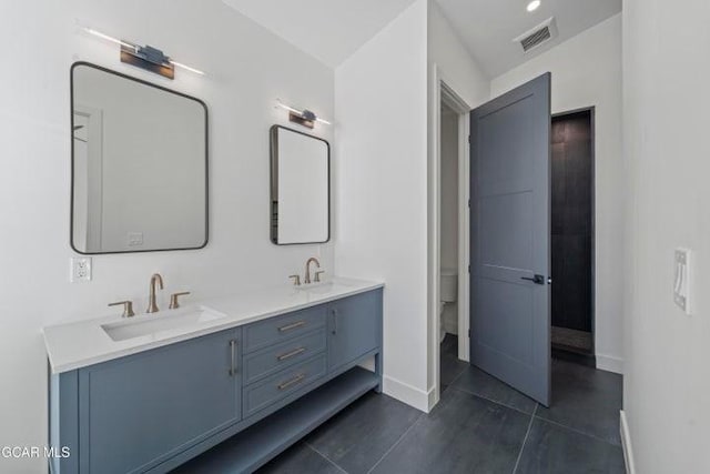 bathroom with tile patterned floors, vanity, and toilet