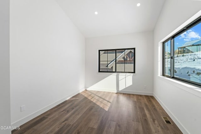 unfurnished room with dark hardwood / wood-style flooring