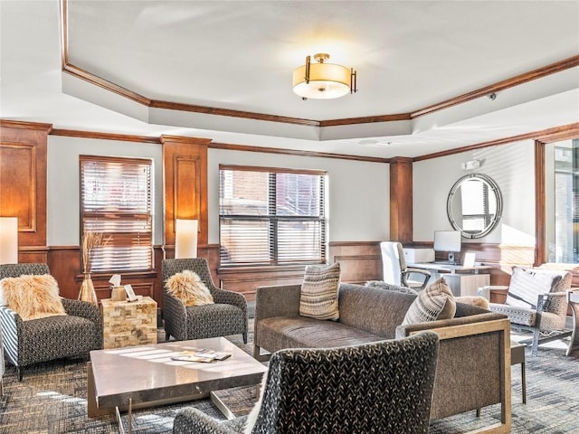 interior space featuring wooden walls, ornamental molding, and a tray ceiling