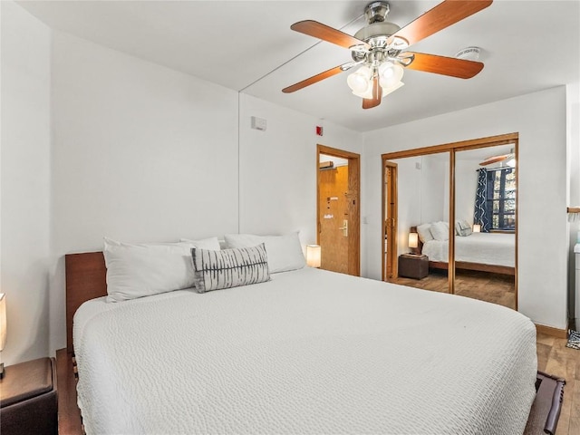 bedroom featuring hardwood / wood-style flooring, a closet, and ceiling fan