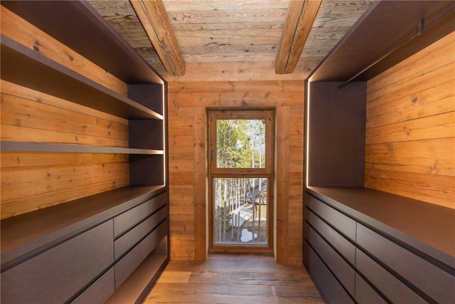 spacious closet with beam ceiling and wood-type flooring