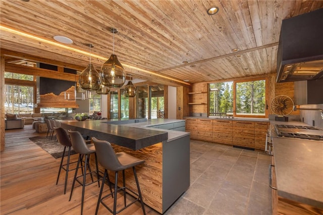 kitchen featuring pendant lighting, a breakfast bar area, and wood ceiling