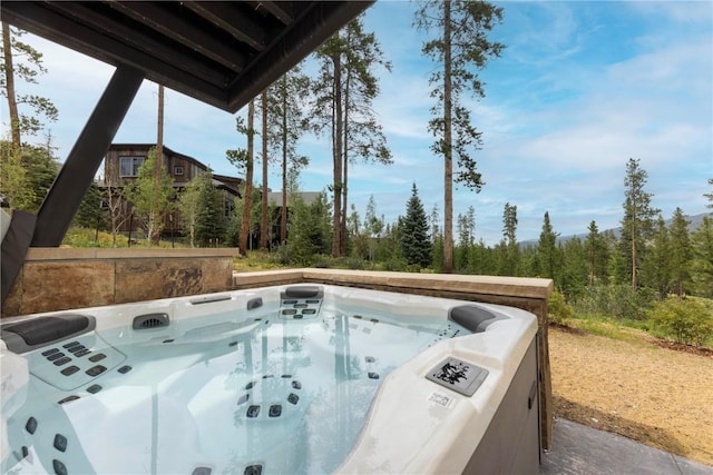 view of pool with a hot tub